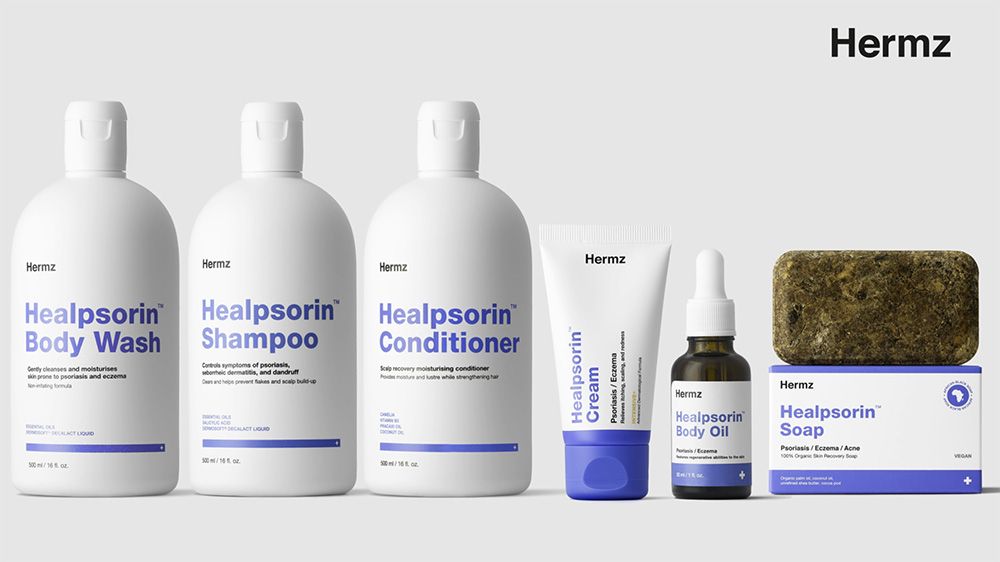 Kolekcja produktów marki Hermz, w tym płyn do mycia ciała, szampon, odżywka, krem, olejek i mydło, wszystkie oznaczone jako zawierające "Healpsorin" i wyświetlane na jasnoszarym tle.